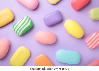 Different soaps in different soap dishes. A lot of solid soap for hygiene and cleanliness. Colorful soap and remnants are scattered on purple table. - Powered by Shutterstock