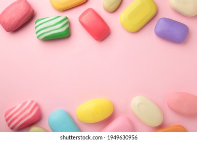 Different soaps in different soap dishes. A lot of solid soap for hygiene and cleanliness. Colorful soap and remnants are scattered on pink background. - Powered by Shutterstock