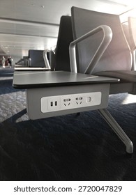 different socket tipes in empty waiting area near gate in terminal at airport