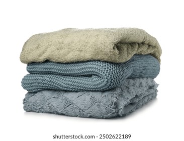 Different soft folded blankets on white background