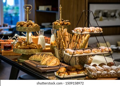 Different sorts of bagels, bread and pastry served at breakfast buffet.