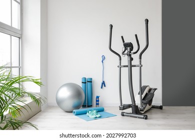Different sports equipment and fitness ball in gym - Shutterstock ID 2027992703