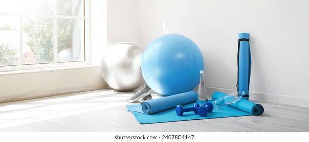 Different sports equipment in light room - Powered by Shutterstock