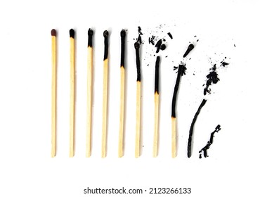 Different stages of match burning. A row of burnt matches, from almost a whole match to a completely burnt match to the dust. White background, flat lay.
