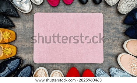 Different styles of shoes are placed in a circle on a wooden floor. A pink mat is in the center, creating space for details.