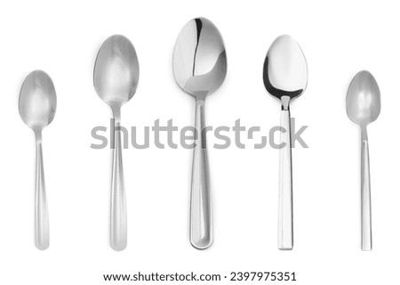 Different stylish silver spoons on white background