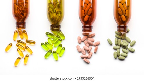 Different supplement pills with bottles on white background