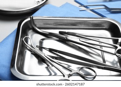 Different surgical tools on light gray background, closeup