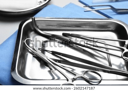 Different surgical tools on light gray background, closeup