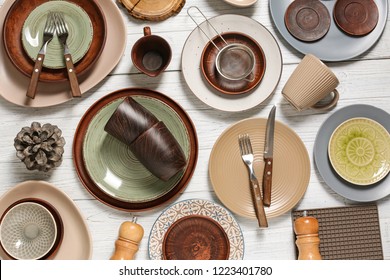 Different Tableware And Cutlery On Wooden Table