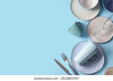 Different tableware on blue background. Top view