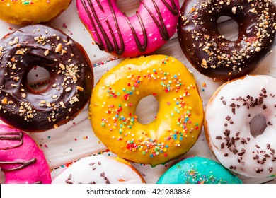Different tasty donuts on a white background top view