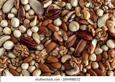 Different tasty nuts in a heap. Nuts background - Shutterstock ID 1894988572