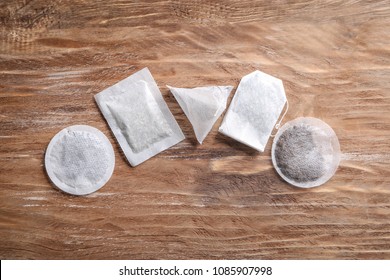 Different Tea Bags On Wooden Background