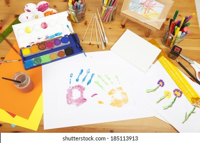 Different Things Lying On A Table To Try Arts And Crafts, Painted By Kids