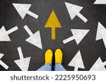 Different thinking and Business and technology disruption concept. Yellow big arrow opposite direction with white arrow on road asphalt. Standing out from the crowd
