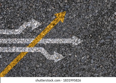 Different thinking and Business and technology disruption concept , Yellow arrow cross direction with white arrow on road asphalt. 