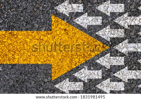 Different thinking and Business and technology disruption concept. Yellow big arrow opposite  direction with white arrow on road asphalt. 