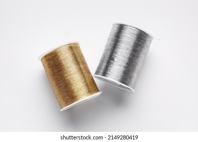 Different thread spools on white background