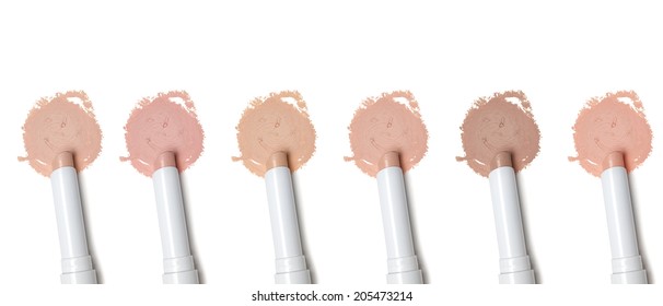 Different Tones Of Makeup Concealer Pencil On White Background