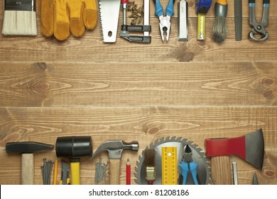 Different tools on a wooden background. - Shutterstock ID 81208186