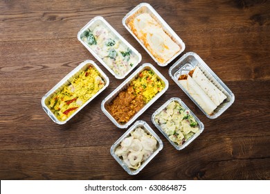 Different Type Of Ready Tasty Meals In Foil Containers On The Table - Shutterstock ID 630864875