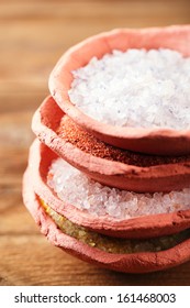 different type of salt in rustic clay bowls   stacked, Himalayan Pink Crystal Rock salt, Hawaiian Red Alaea Sea Salt, Persian Blue Iranian, Lemon Salt