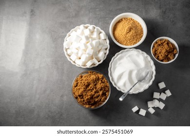  Different type of sugar. Light brown, dark brown and white sugar cubes in bowls.