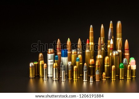 Different types of ammunition on a black background. Sale of weapons and ammunition. The right to hold a gun