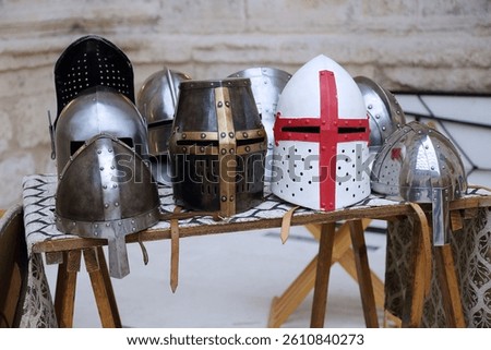 Different types of armor helmets displayed at a medieval fair