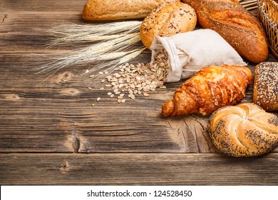 Different types of baked goods on wooden background