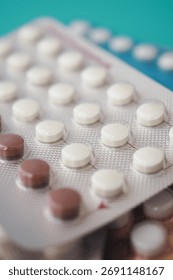 Different types of birth control pills in a plastic blister pack