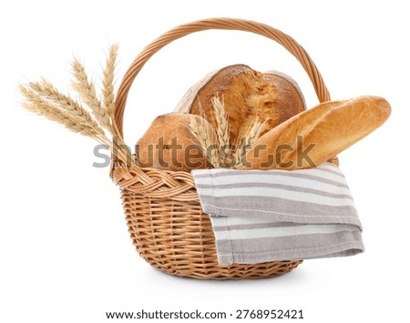 Different types of bread and spikes in wicker basket isolated on white