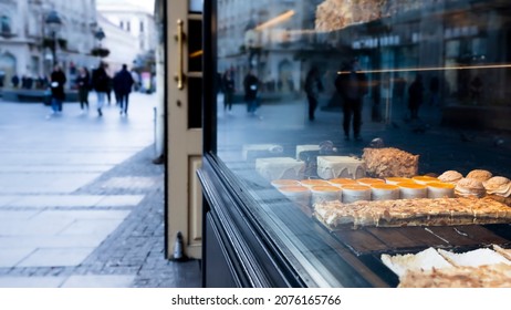 Different types of cakes in pastry shop glass display