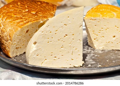 Different types of cheese on the table. Many cheese is sold at an agricultural fair. Natural home product.