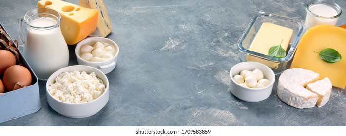 Different Types Of Dairy Products On Grey Background. Panorama, Banner With Copy Space