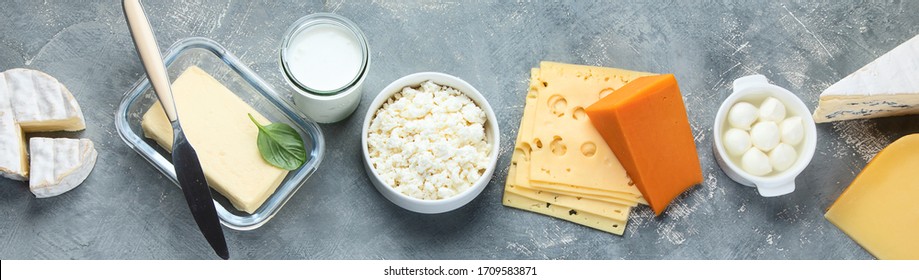 Different Types Of Dairy Products On Grey Background. Top View. Panorama, Banner