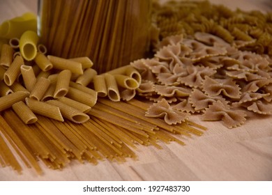 Different types of dried pasta stock images. Group of dried uncooked wholemeal pasta on the table stock images. Mixed uncooked italian pasta close-up photo