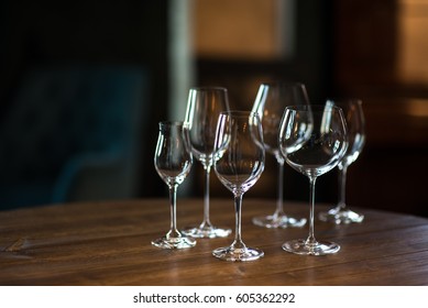 Different types of glasses for wine on wooden table. Still life concept. - Powered by Shutterstock