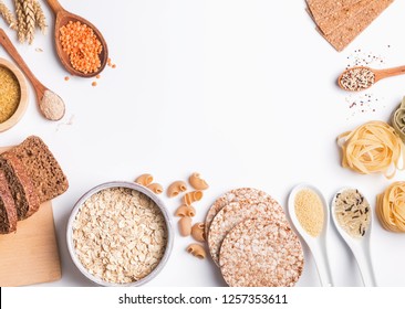 Different Types Of High Carbohydrate Food. Flour, Bread, Dry Pasta And Lentils And Other Ingredients On The White Background.