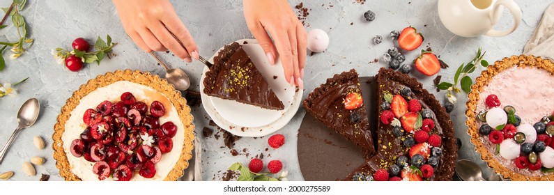 Different types of homemade tarts on light gray background. Top view, flat lay, panorama, banner
