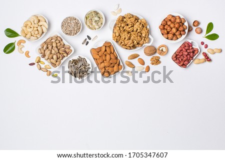 Different types of nuts in composition on white background in studio