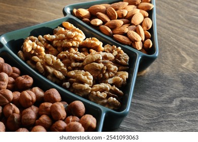 different types of nuts, Various snacks for the New Year table in a plate in the shape of a Christmas tree.