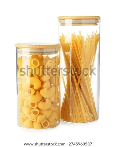 Different types of pasta in jars isolated on white