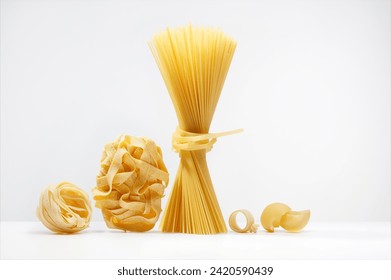 Different types of pasta on a white background. Variety of types and shapes of Italian pasta.  - Powered by Shutterstock