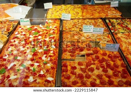 Different types of pizza are sold in a street food cafe in Italy