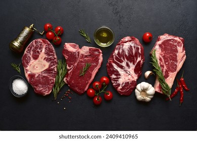 Different types of raw marbled beef steaks : T-bone, ossobuko, spider and rib eye with ingredients for cooking. Top view with copy space. - Powered by Shutterstock