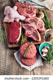 Different Types Of Raw Meat - Beef, Pork, Lamb, Chicken On A Wooden Board.