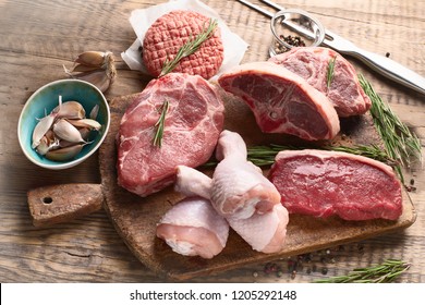 Different Types Of Raw Meat - Beef, Pork, Lamb, Chicken On A Wooden Board.