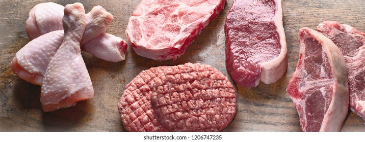 Different Types Of Raw Meat - Beef, Pork, Lamb, Chicken On A Wooden Board.  Panorama